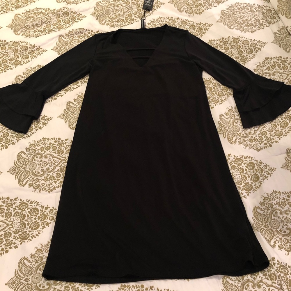 Black dress, close to the knees in length.